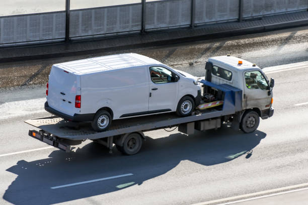 Truck carrier with mini van in the asphalt road_WR Towing